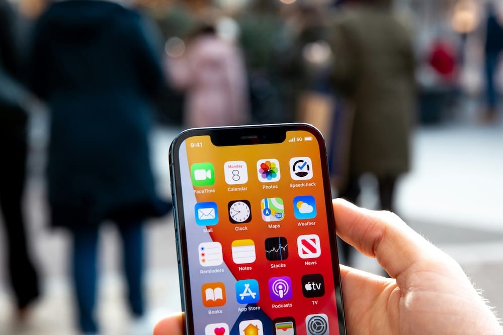 Image of a hand holding an iPhone