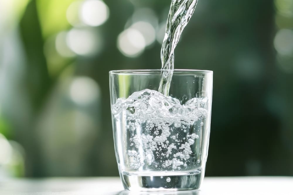 Image of water being poured into a glass